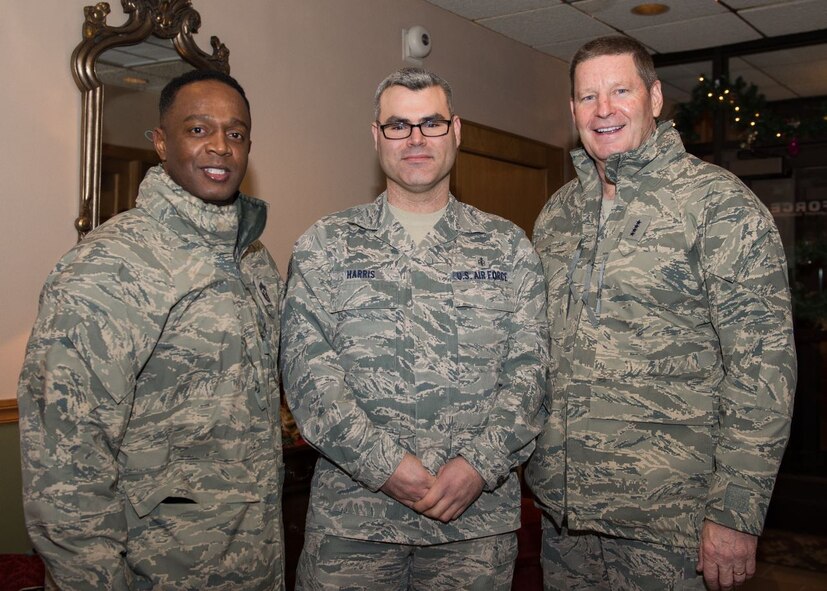 Gen. Robin Rand, AFGSC commander, and Chief Master Sgt. Calvin Williams, AFGSC command chief, recognize Tech. Sgt. Sergio Harris, 5th Medical Support Squadron staff NCO in charge of the resource management office, at Minot AFB, North Dakota. Rand and Williams visited Team Minot Nov. 30 - Dec. 2. (U.S. Air Force photo/Airman 1st Class J.T. Armstrong)