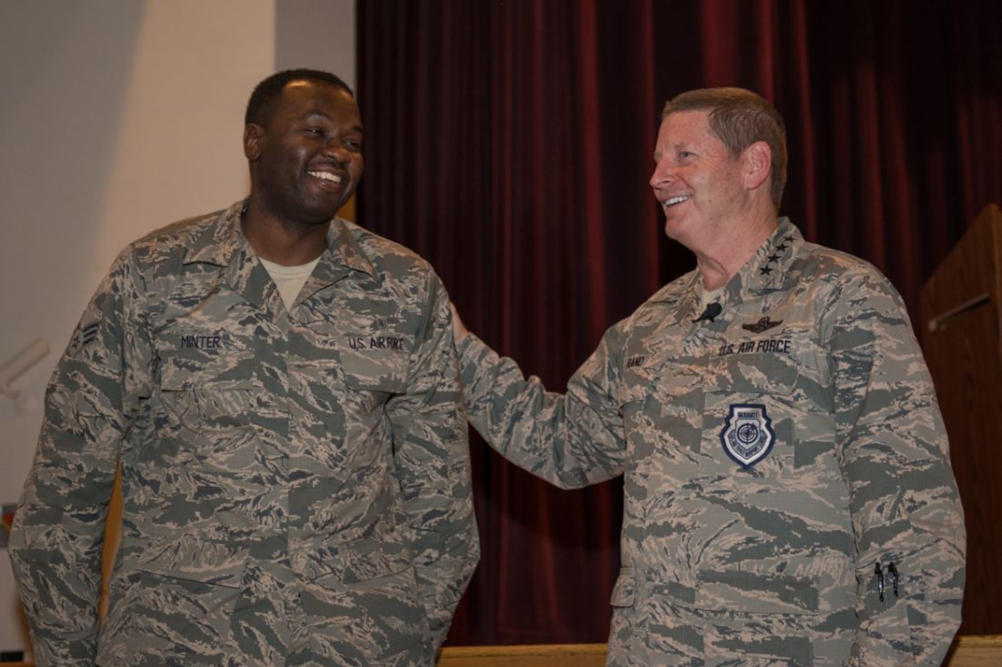 Gen. Robin Rand, AFGSC commander, speaks with Senior Airman Karlton Minter, 5th Medical Operations Squad ambulance services, during an enlisted all call at Minot AFB, North Dakota. Rand recognized outstanding Airmen and civilians during the all call, which focused on his priorities as AFGSC’s commander. (U.S. Air Force photo/Airman 1st Class J.T. Armstrong)