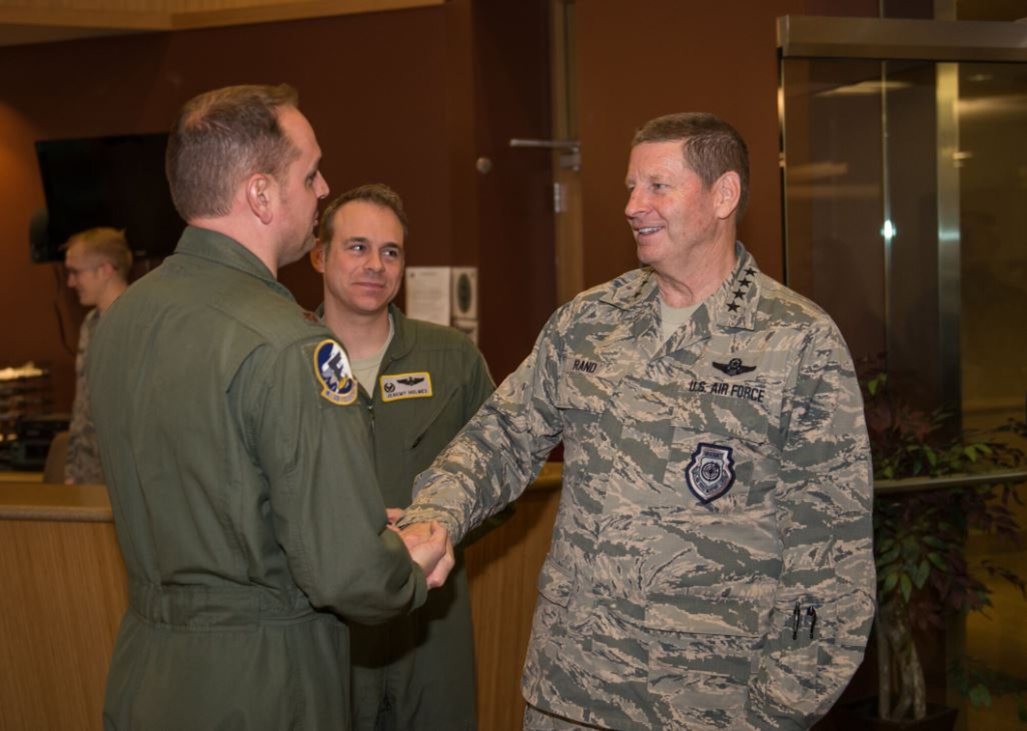 Gen. Robin Rand, AFGSC commander, coins Maj. Luke Dallenback, 69th Bomb Squadron assistant director of operations, at Minot AFB, North Dakota. Rand visited Team Minot Nov. 30 - Dec. 2, meeting with 5th Bomb Wing and 91st Missile Wing Airmen. (U.S. Air Force photo/Airman 1st Class J.T. Armstrong)