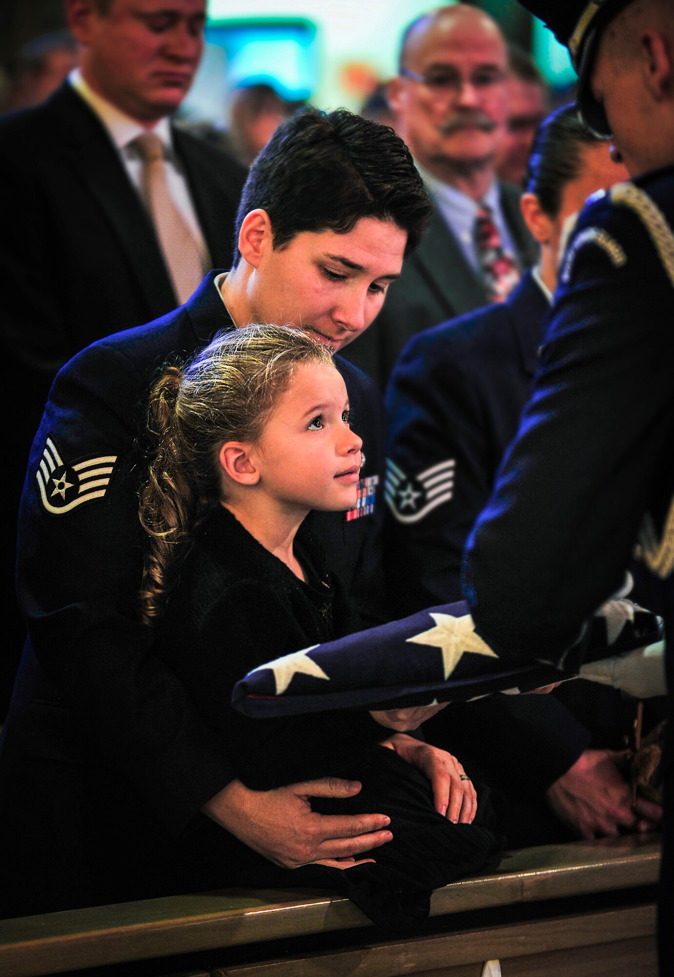 Sophia Gonzalez receives a folded flag from an honor guard member during the funeral of her father, Master Sgt. Matthew Gonzalez, at Minot Air Force Base, N.D., Oct. 26, 2015. Four-year-old Sophia, who was referred to as “Sophia Bear” by her late father, was Gonzalez’s only child. (U.S. Air Force photo/Senior Airman Stephanie Morris)