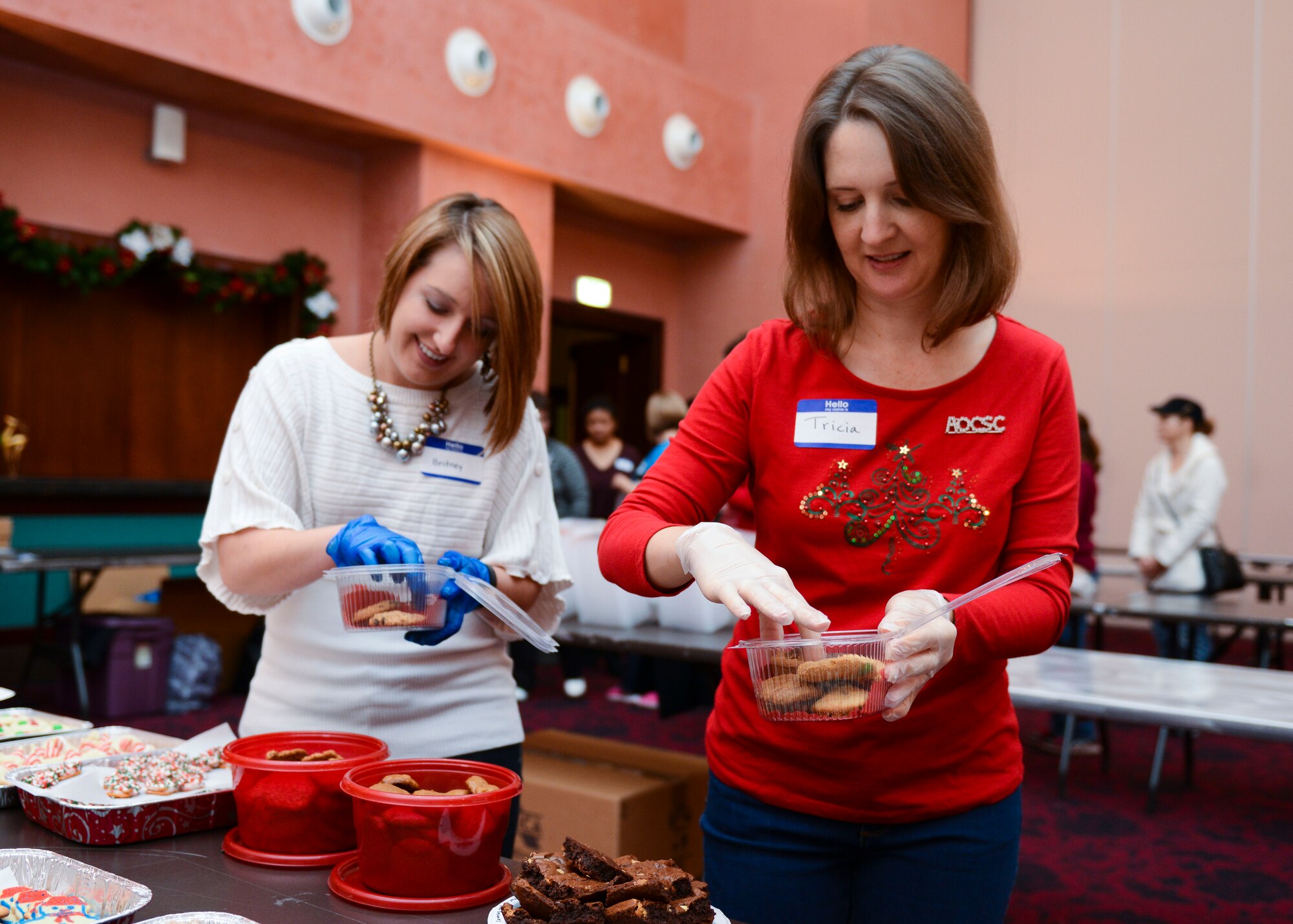 Britney Manning and Tricia Boles, Team Aviano spouses, prepare boxes of cookies during the annual holiday cookie drive, Dec. 7, 2015, at Aviano Air Base, Italy. Approximately 750 U.S. Air Force Airmen who live in the dormitories will receive the homemade cookies. (U.S. Air Force photo by Senior Airman Austin Harvill/Released)
