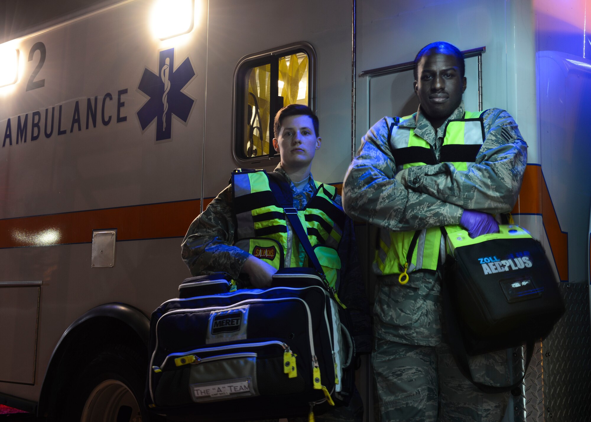 U.S. Air Force Airman 1st Class Kelly Pope and Senior Airman Kayode R. Idris Jr., 31st Medical Operations Squadron emergency medical technicians, stand ready, Dec. 6, 2015, at Aviano Air Base, Italy. The on-call EMTs perform operations out of the fire department after normal working hours. (U.S. Air Force photo by Senior Airman Austin Harvill/Released)