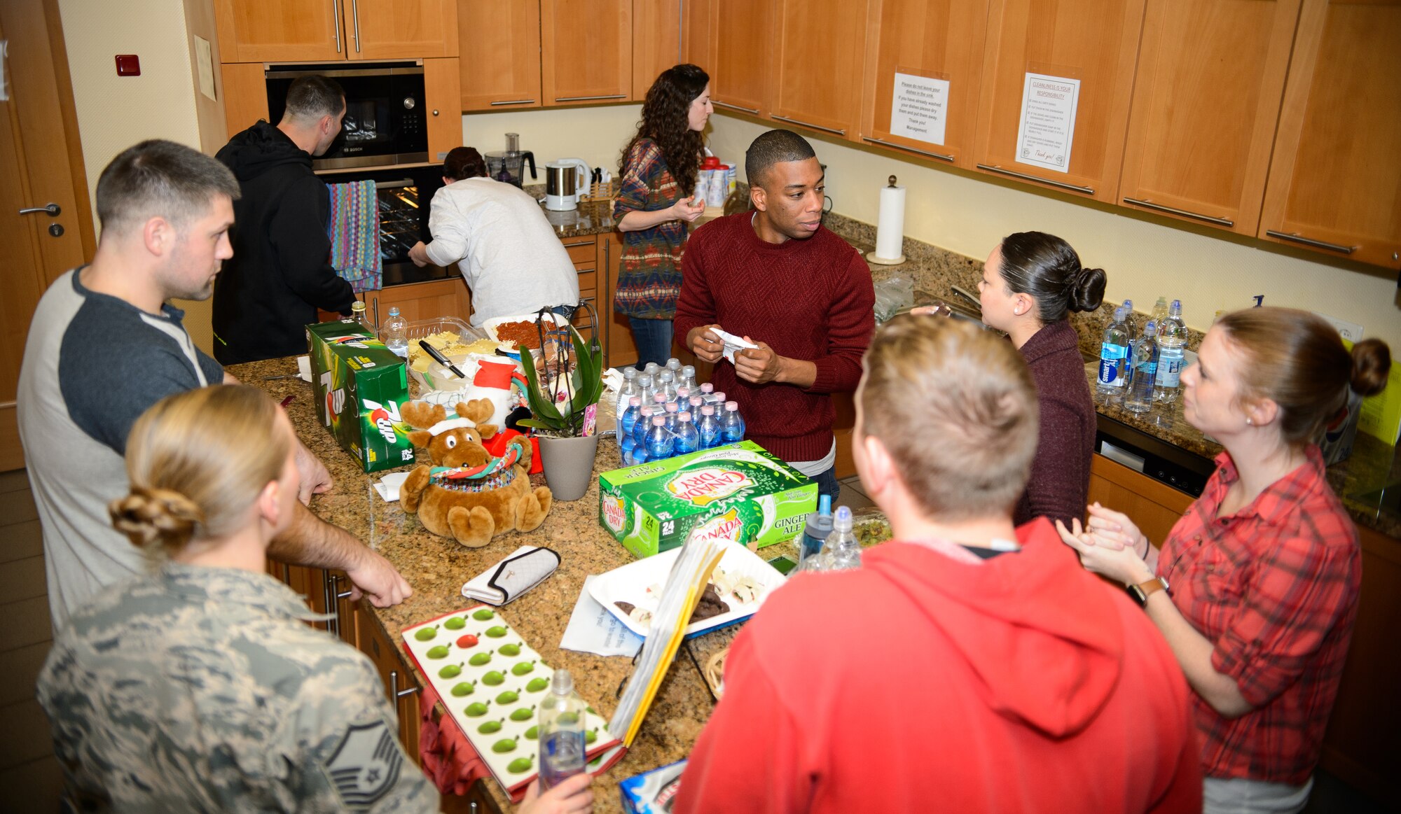 Members of the 450th Intelligence Squadron cook meals for the Landstuhl Fisher House Dec. 4, 2015, at Landstuhl Reginal Medical Center, Germany. Volunteers from the 450th IS scattered throughout the Kaiserslautern Military Community to give their time to the annual Special Olympics, Landstuhl Fisher House, Junior ROTC and military post offices. (U.S. Air Force photo/Staff Sgt. Armando A. Schwier-Morales)