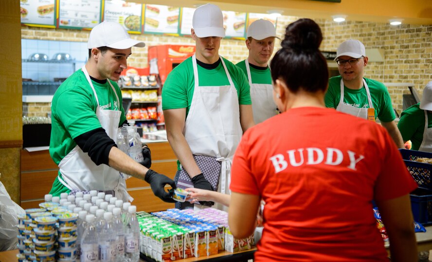 Master Sgt. Allen Lewis, 450th Intelligence Squadron first sergeant, gives a snack to annual Special Olympics participants Dec. 4, 2015, at Vogelweh Military Complex, Germany. Members of the 450th IS took a day to give back to the local community in a variety of ways to help not only improve their community but also boost squadron camaraderie through service to others. (U.S. Air Force photo/Staff Sgt. Armando A. Schwier-Morales)