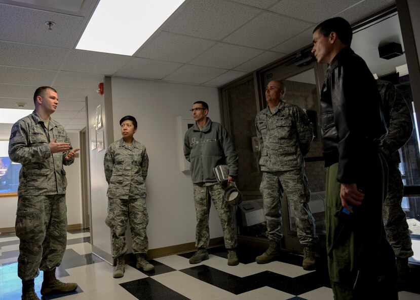 U.S. Air Force Staff Sgt. Jacey Thompson, an Airman Dorm Leader, discusses recent projects at Atlantis Hall during a dorm quality-of-life tour for Brig. Gen. Paul W. Tibbets IV, the 509th Bomb Wing (BW) commander, and Chief Master Sgt. Shawn Drinkard, the 509th BW command chief, at Whiteman Air Force Base, Mo., Dec. 1, 2015. Recent projects include adding surveillance cameras for safety purposes, providing new furniture for common areas, and creating opportunities for Airmen to socialize and enjoy their down time. (U.S. Air Force photo by Senior Airman Sandra 