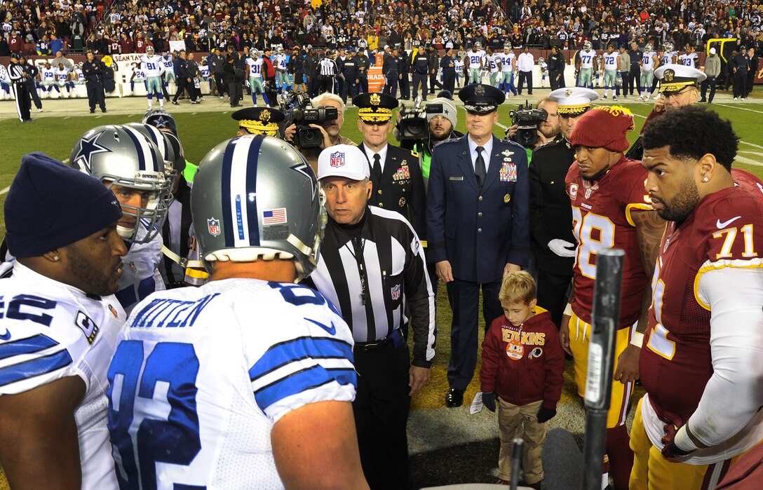 Air Force District of Washington Commander Maj. Gen. Darryl Burke observes the coin toss for the Washington Redskins versus Dallas Cowboys game, Dec. 7, 2015 at FedEx Field in Landover, Md. The Washington Redskins continued their tradition of honoring the nation's veterans and active duty military through the team's annual Salute to Service game. (U.S. Air Force photo by James E. Lotz/RELEASED).