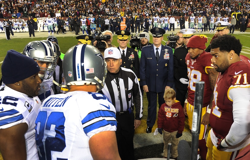 Air Force District of Washington Commander Maj. Gen. Darryl Burke observes the coin toss for the Washington Redskins versus Dallas Cowboys game, Dec. 7, 2015 at FedEx Field in Landover, Md. The Washington Redskins continued their tradition of honoring the nation's veterans and active duty military through the team's annual Salute to Service game. (U.S. Air Force photo by James E. Lotz/RELEASED).