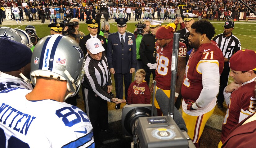 Air Force District of Washington Commander Maj. Gen. Darryl Burke observes the coin toss for the Washington Redskins versus Dallas Cowboys game, Dec. 7, 2015 at FedEx Field in Landover, Md. The Washington Redskins continued their tradition of honoring the nation's veterans and active duty military through the team's annual Salute to Service game. (U.S. Air Force photo by James E. Lotz/RELEASED).