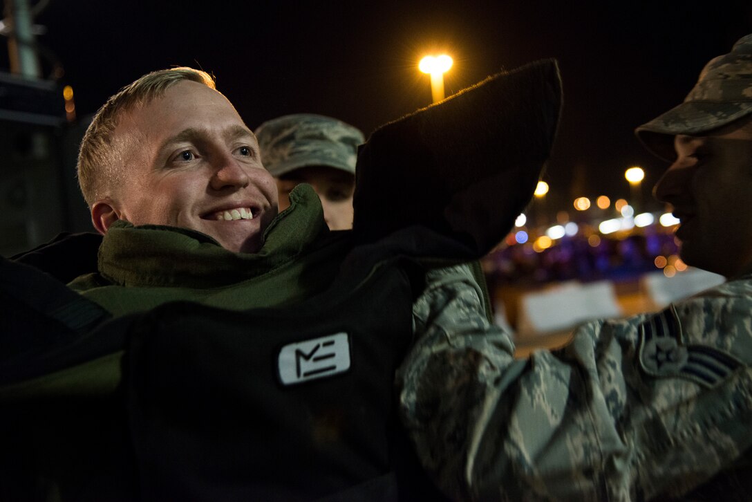 Sam Roeshtine, Washington Redskins fan, wears and controls an explosive ordnance disposal bomb suit outside FedEx Field Landover, Md., Dec. 7, 2015. The 11th Civil Engineer Squadron's EOD flight displayed capabilities to the public during a Redskins Salute night with Tech. Sgt. Christopher Ferrel, a member of the 11 CES, pinning on the Purple Heart medal during halftime of the football game. (U.S. Air Force photo by Airman 1st Class Philip Bryant/Released) 