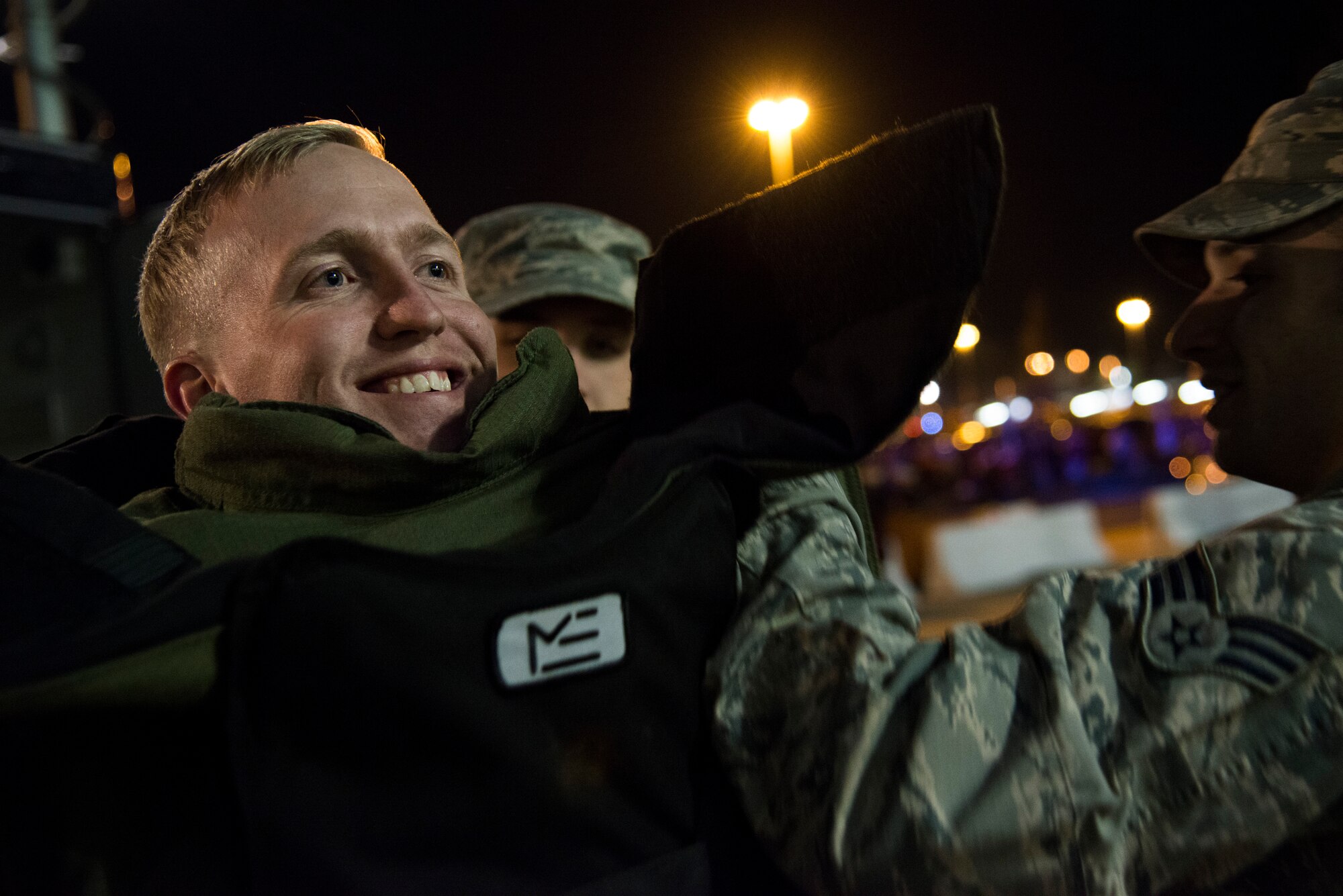 Sam Roeshtine, Washington Redskins fan, wears and controls an explosive ordnance disposal bomb suit outside FedEx Field Landover, Md., Dec. 7, 2015. The 11th Civil Engineer Squadron's EOD flight displayed capabilities to the public during a Redskins Salute night with Tech. Sgt. Christopher Ferrel, a member of the 11 CES, pinning on the Purple Heart medal during halftime of the football game. (U.S. Air Force photo by Airman 1st Class Philip Bryant/Released) 