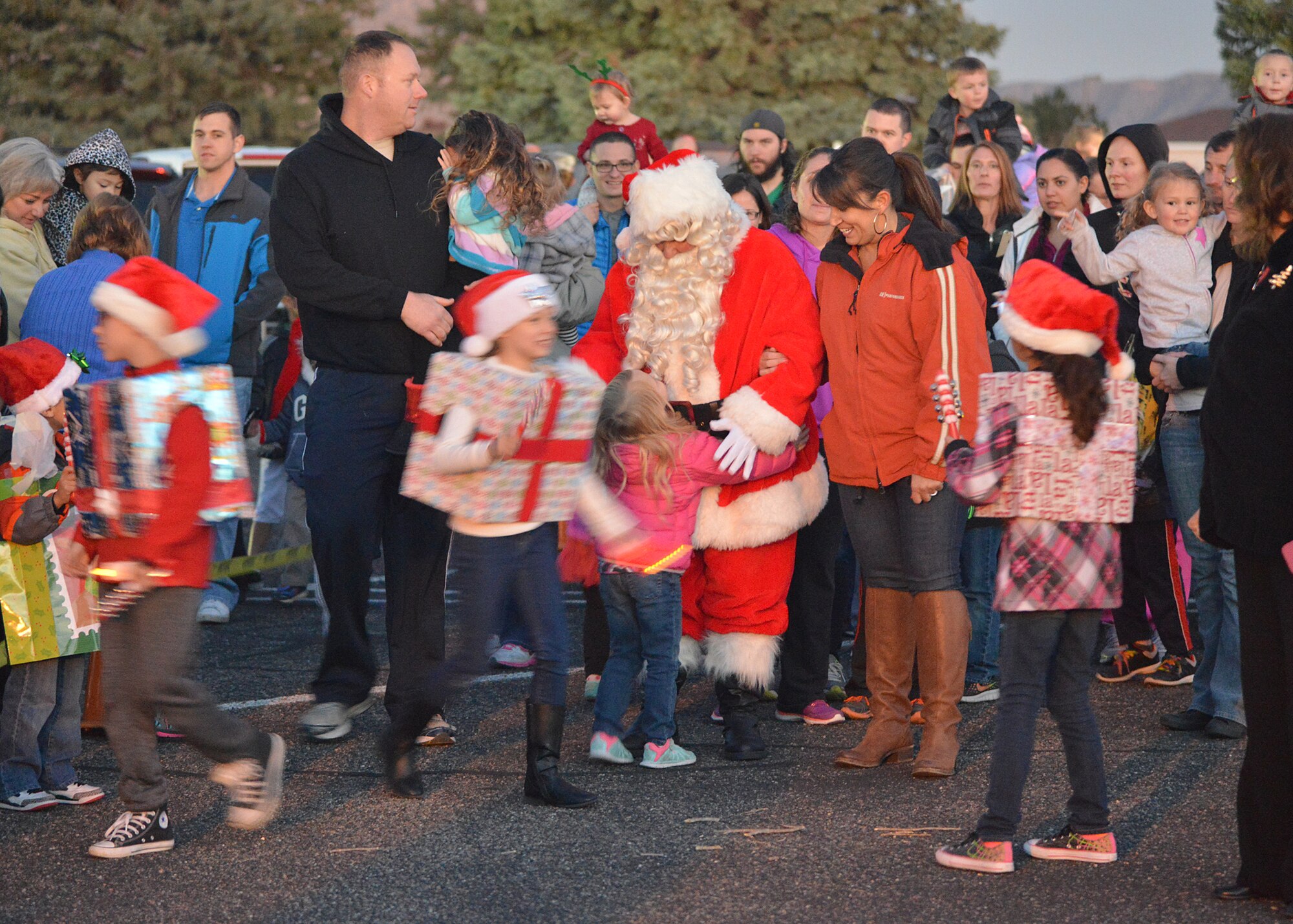 Children gather around Santa Claus at the annual tree lighting Dec. 3. Team Kirtland members gathered outside the Base Chapel for the tree lighting, followed by Santa visits, caroling, arts and crafts and refreshments. (Photo by Todd Berenger)