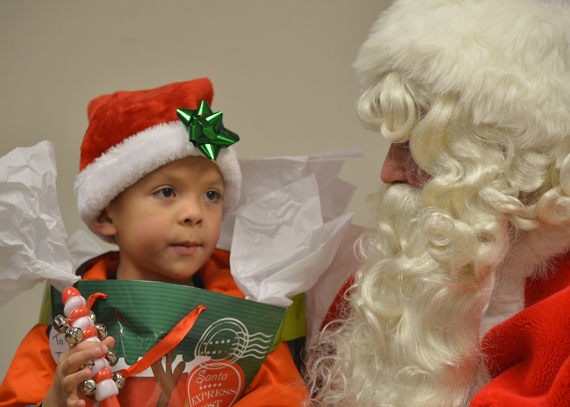 Daniel Velasquez, 6, shares his Christmas wishlist with Santa Claus during the annual tree lighting Dec. 3. Team Kirtland members gathered outside the Base Chapel for the tree lighting, followed by Santa visits, caroling, arts and crafts and refreshments. (Photo by Todd Berenger)