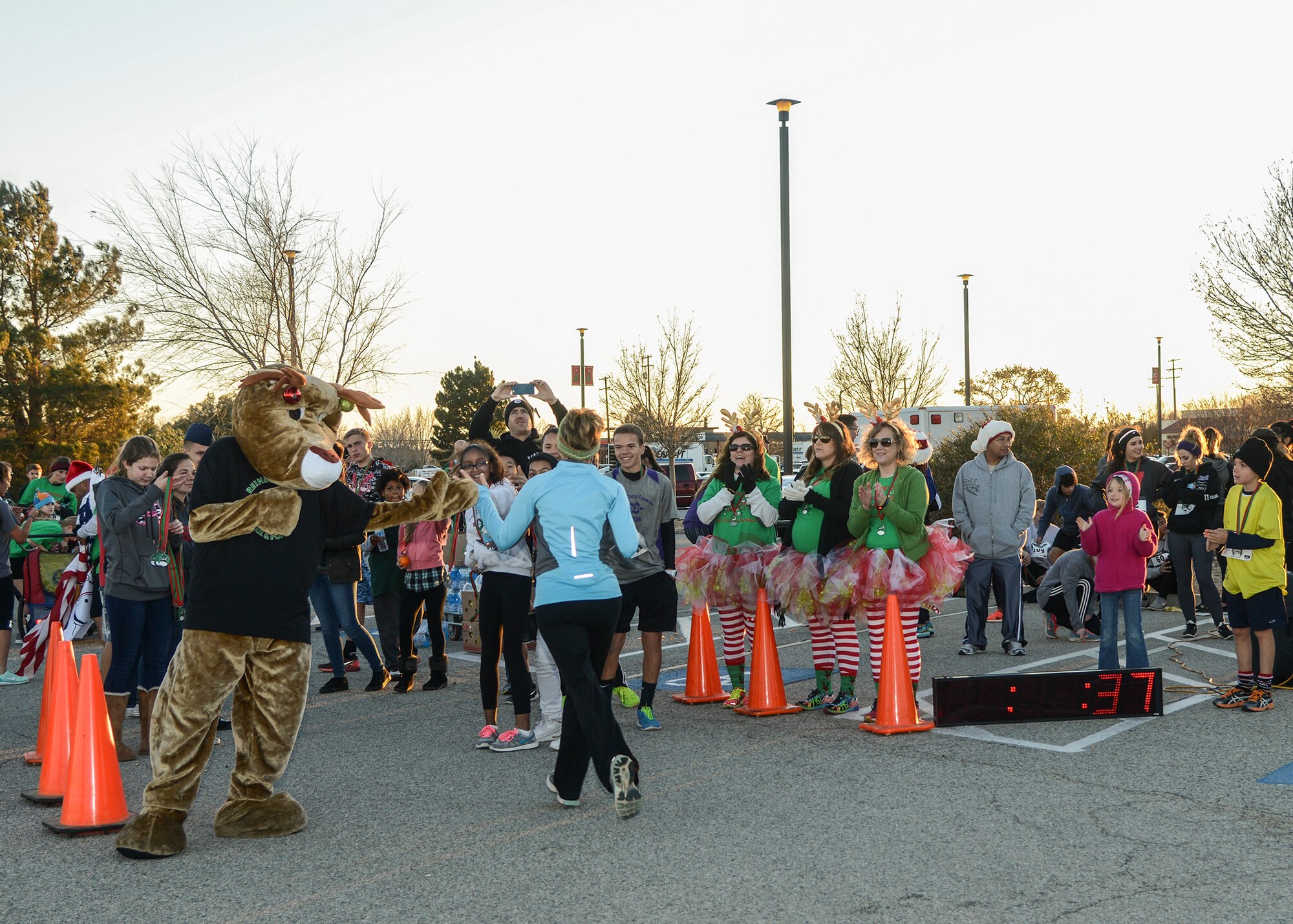 Edward the Reindeer high-fived each runner as they crossed the finish line at the 7th Annual Reindeer Run held Dec. 4. (U.S. Air Force photo by Rebecca Amber)