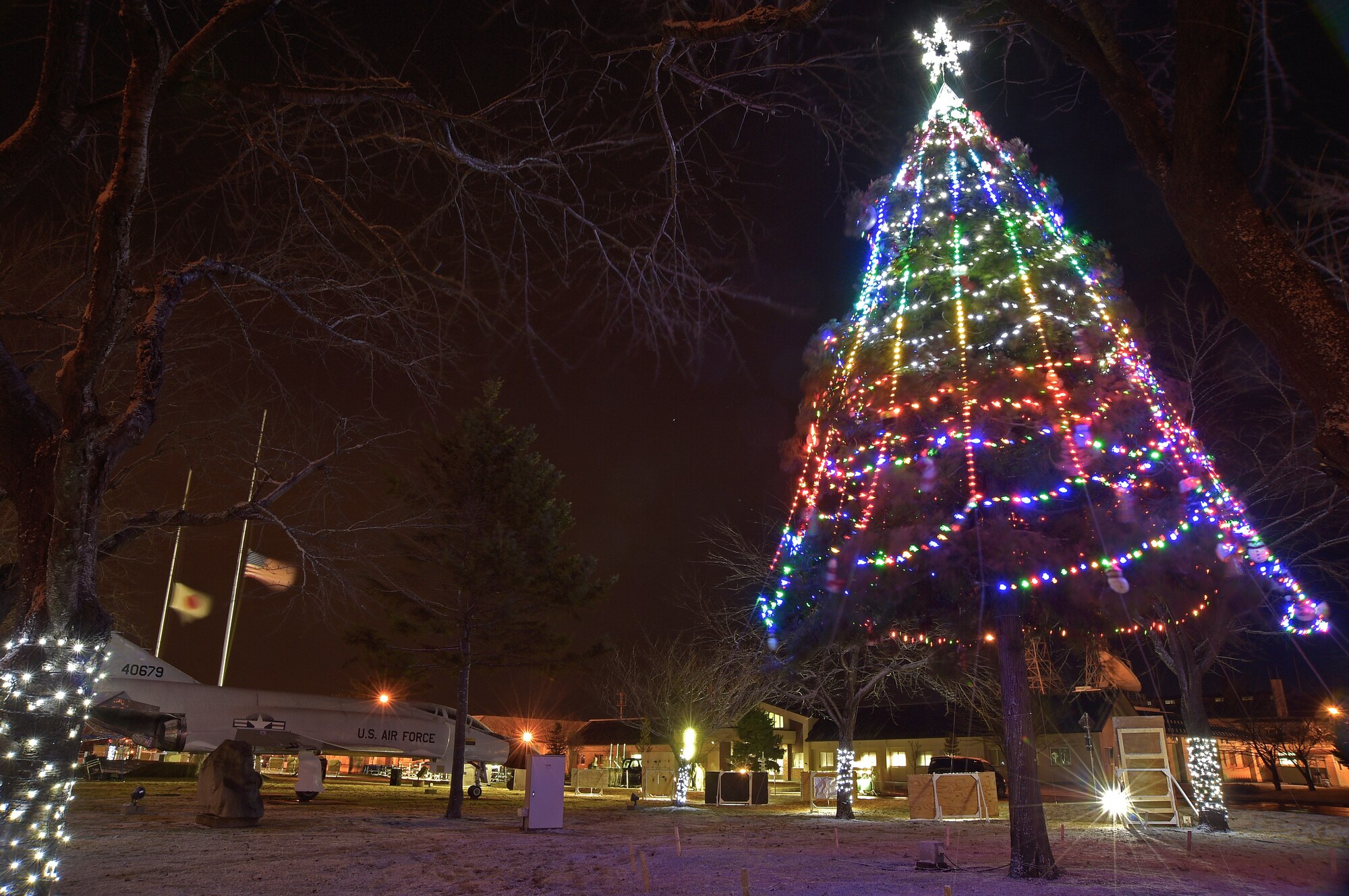 Lights shine brightly on the base Holiday tree at Misawa Air Base, Japan, Dec. 4, 2015. Each year Risner Circle is decorated with lights, illuminating the area with holiday spirit. (U.S. Air Force photo by Senior Airman Jose L. Hernandez-Domitilo)