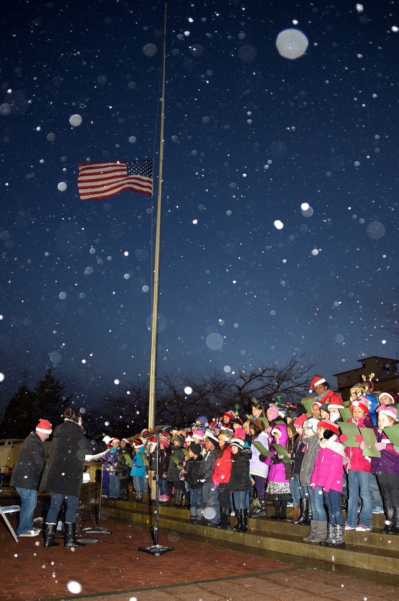 Misawa Air Base choir students perform a holiday carol during the annual Holiday Tree Lighting Ceremony here, Dec. 4, 2015. As an annual tradition, choir students from Sollars Elementary School, Edgren High School and Misawa City came to perform for the audience as part of the ceremony entertainment. (U.S. Air Force photo by Senior Airman Jose L. Hernandez-Domitilo)