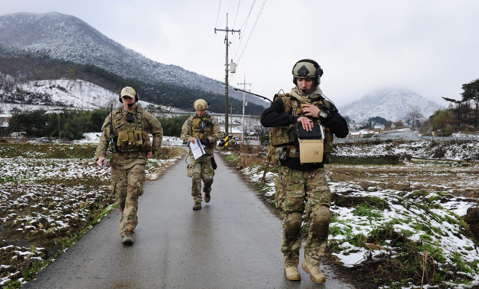 Tech. Sgt. Patrick Naughton, 1st. Lt. Austin Hairfield and Senior Airman William Irvin, all 604th Air Support Operations Squadron tactical air control party members, use radio systems to coordinate with pilots as part of Exercise Woody Cloud 16-1, Dec. 4, 2015. The first-ever exercise simulated scenarios of events JTAC Airmen experienced during previous tours in Iraq and Afghanistan. (U.S. Air Force photo by Staff Sgt. Nick Wilson/Released)