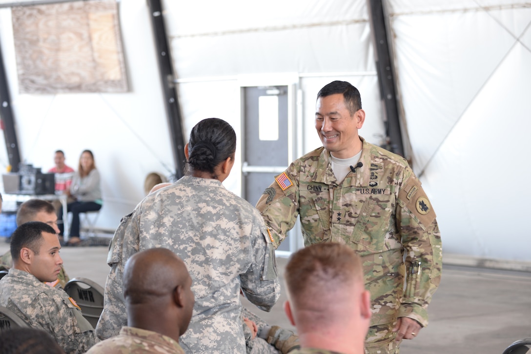 U.S. Army Maj. Gen. K.K. Chinn, Army South commander, gives a coin to a Soldier stationed at Soto Cano Air Base, Honduras, Dec. 8, 2015. Chinn came to Soto Cano to give the Soldiers a better idea of how their work is helping to build relationships between partner nations throughout the Central American area of responsibility. (U.S. Air Force photo by Senior Airman Westin Warburton/Released)