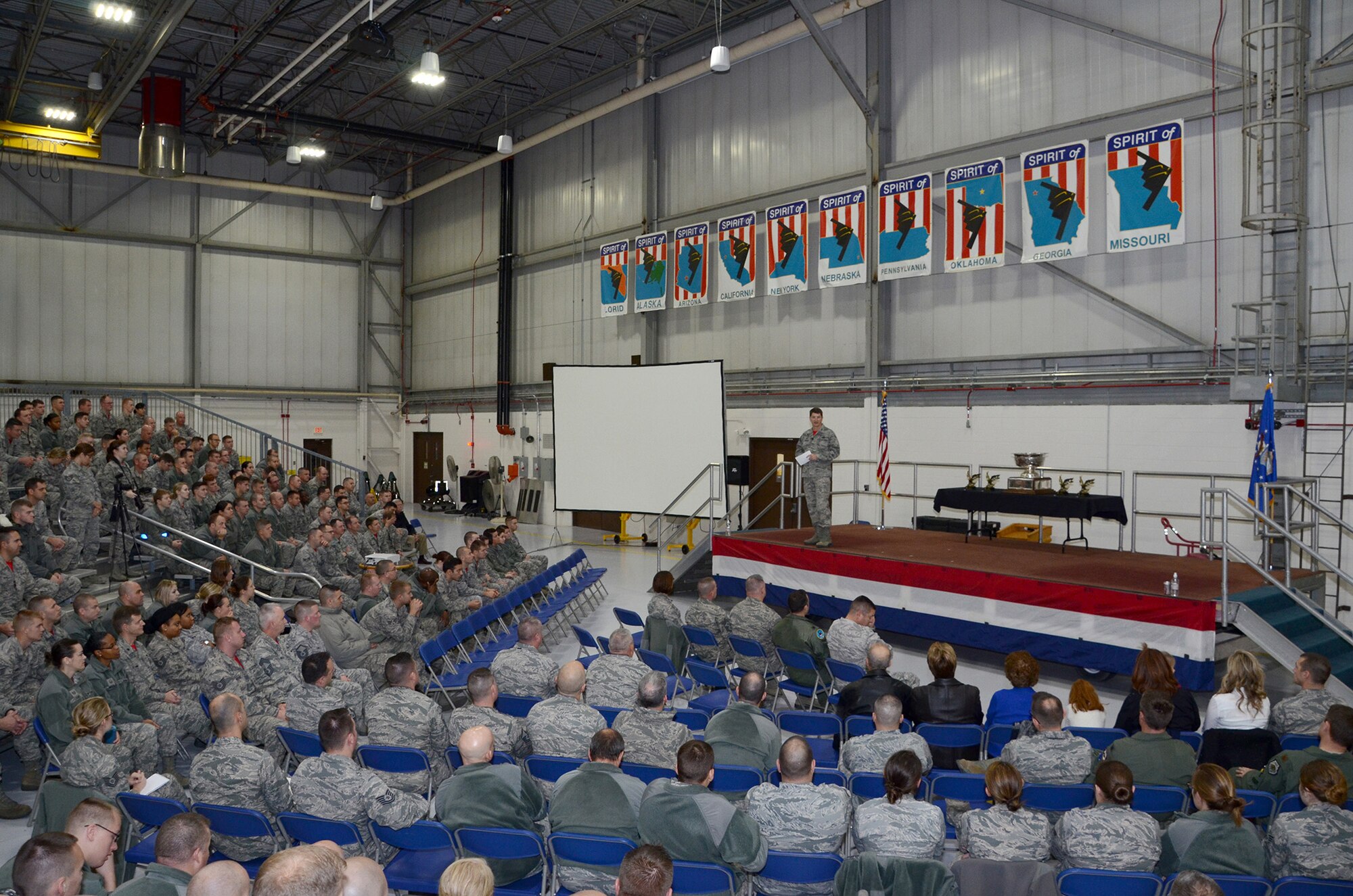 The 131st Bomb Wing commander, Col. Mike Francis, addresses assembled Citizen Airmen at Whiteman Air Force Base, Missouri, during the end-of-year commander’s call to review significant events and recognize Outstanding Airmen of the Year winners, December 6. 2015. Noting that all commanders tell their units they’re busy, Francis emphasized how true that statement is for the 131st, adding, “They’re not doing it in the B-2.  They’re not doing it in the nuclear enterprise.”   (U.S. Air National Guard photo by Staff Sgt. Brittany Cannon) 


