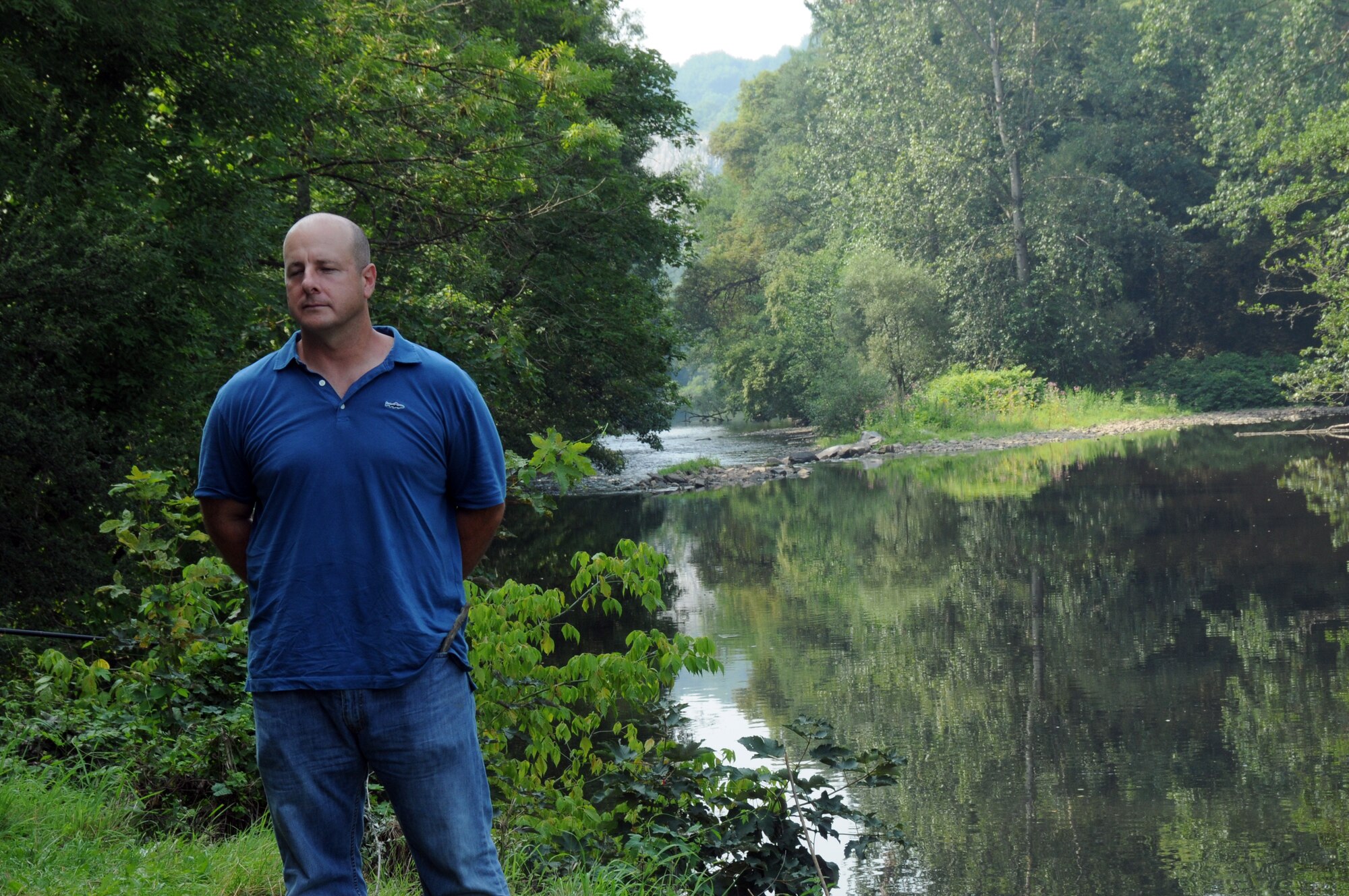 A picture of U.S. Air Force Chief Master Sgt. James McCloskey stands along the banks of the Ambleve River near Aywaille, Belgium.