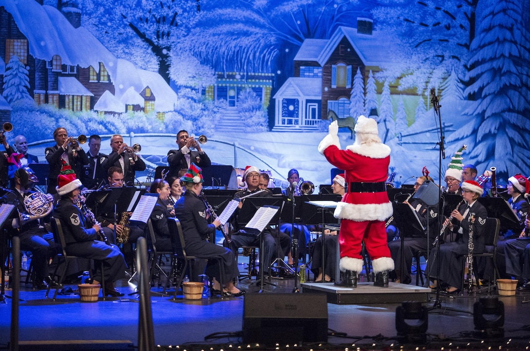 Santa Clause conducts members of the USAF Band of the West during the Holiday in Blue concert Dec. 7, 2015 at the Edgewood Independent School District Theatre for the Performing Arts in San Antonio, Texas. The concert included a variety of holiday songs from around the world, a children’s story and a sing-a-long. Attendees included members of JBSA, community members and retirees. The Airmen assigned to the band are highly-trained professional musicians who have dedicated themselves to serving their country through music. (U.S. Air Force photo by Johnny Saldivar)