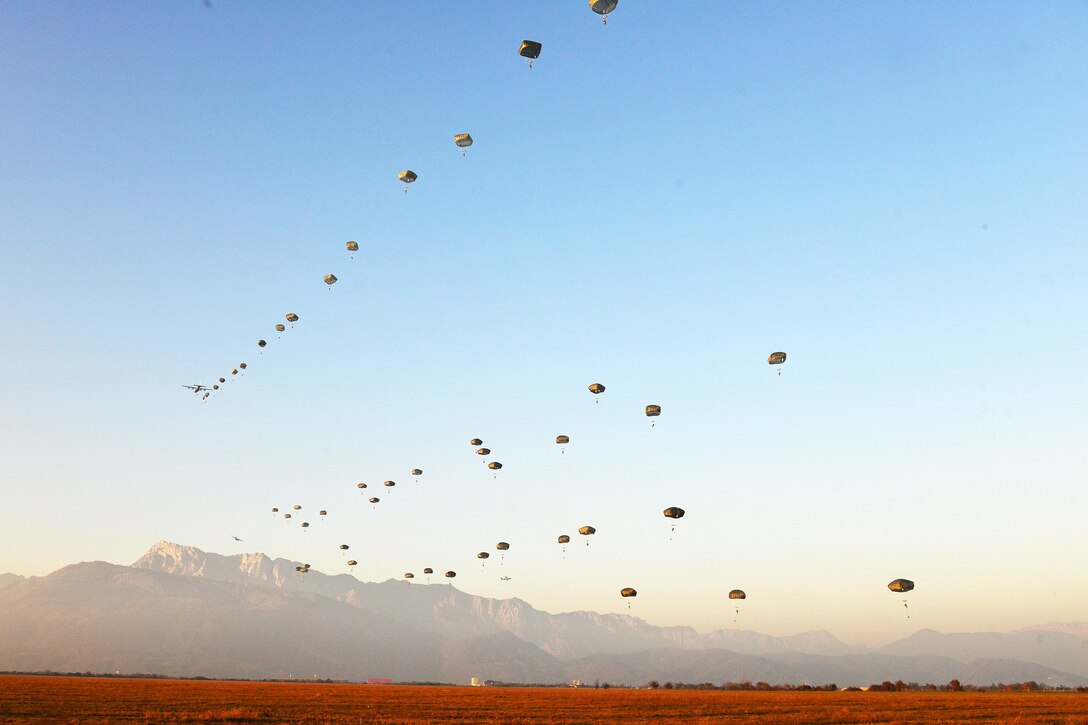 U.S. paratroopers conduct airborne operation from a U.S. Air Force C-130 Hercules aircraft over Juliet drop zone in Pordenone, Italy, Dec. 2, 2015. U.S. Army photo by Paolo Bovo