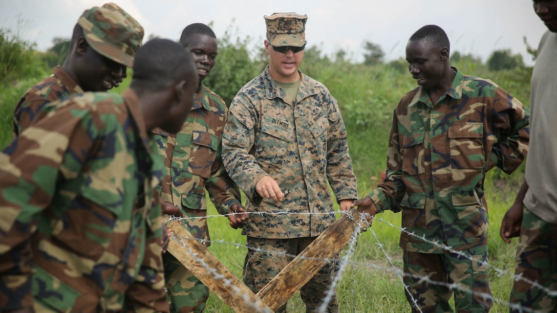 U.S. Marine Cpl. Brandon Ditmire, a combat engineer with Special-Purpose Marine Air-Ground Task Force Crisis Response-Africa, works with Uganda People’s Defense Force soldiers during a civil engineering exercise at Camp Singo, Dec. 7, 2015. The exercise helps the partner nations fortify their civil engineering skills while strengthening the bond between the two. 