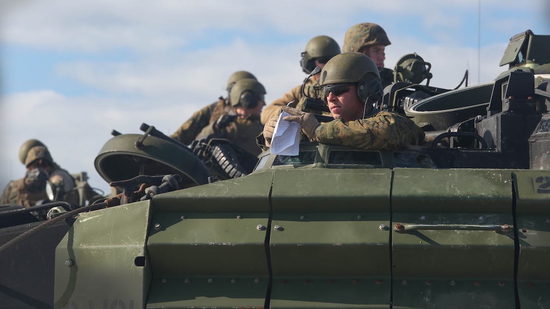 A Marine with Alpha Company, 2nd Assault Amphibian Battalion, waits as his platoon prepares to conduct beach operations on Marine Corps Base Camp Lejeune, N.C., Dec. 5, 2015. The platoon was conducting the exercise alongside the rest of Alpha Company as part of the company-level amphibious assault.