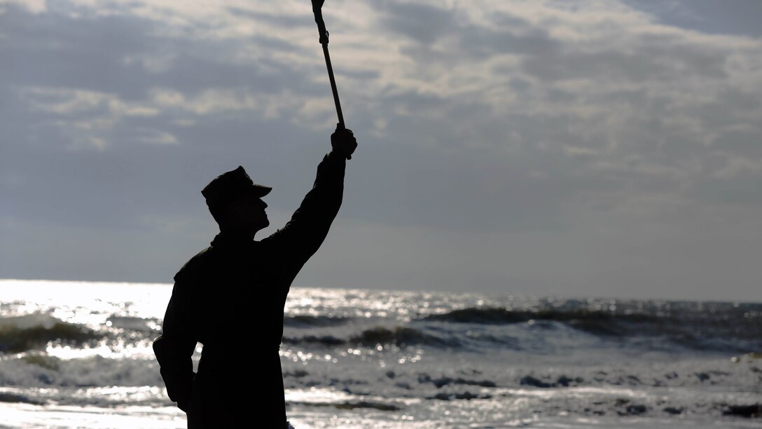 A Marine with Alpha Company, 2nd Assault Amphibian Battalion, gives the signal to start moving out amphibious assault vehicles as the company-level beach operations begin on Marine Corps Base Camp Lejeune, N.C., Dec. 5, 2015. During this exercise the unit conducted maneuvers as a mechanized infantry company in preparation for upcoming operations.