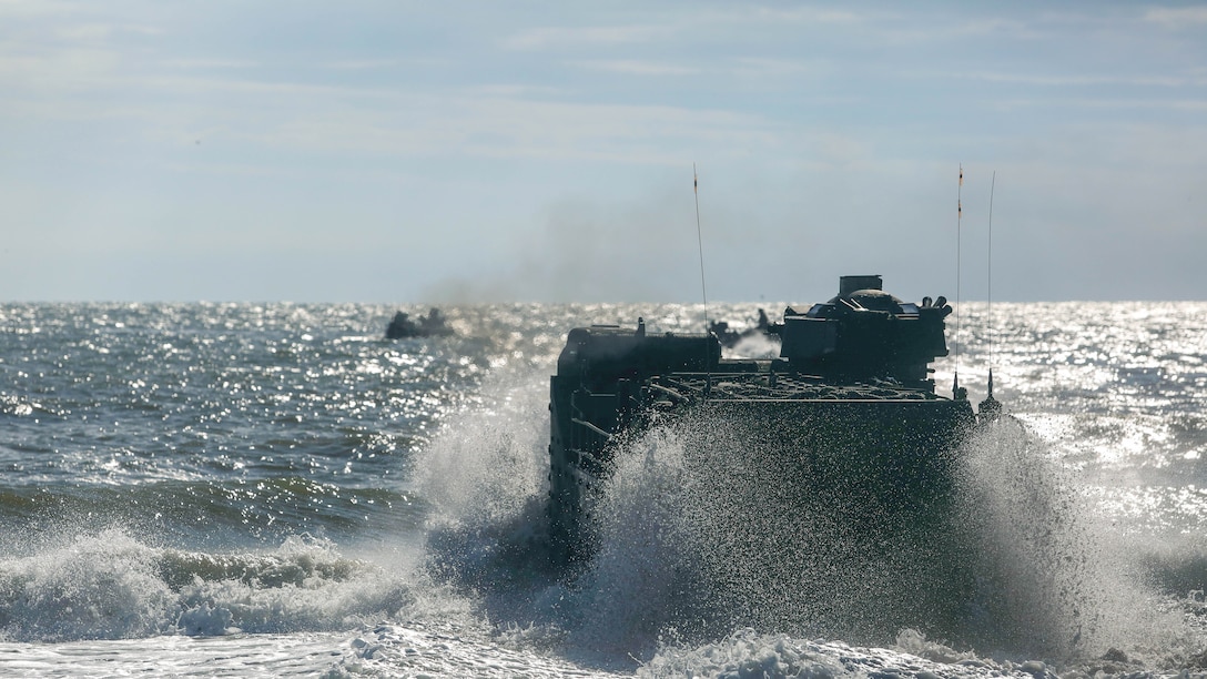 Amphibious Assault Vehicle takes on the surf as Alpha Company, 2nd Assault Amphibian Battalion, conducts company-level beach operations on Marine Corps Base Camp Lejeune, N.C., Dec. 5, 2015. During this exercise waves of AAVs battled the surf and conducted company-level maneuvers at sea and on land.