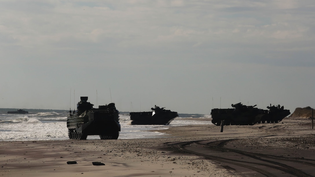 Amphibious Assault Vehicles with Alpha Company, 2nd Assault Amphibian Battalion, take control of the notional enemy beach as part of company-level beach operations on Marine Corps Base Camp Lejeune, N.C. Dec. 5, 2015. Shortly after taking the beach the AAVs pushed forward to their inland objectives.