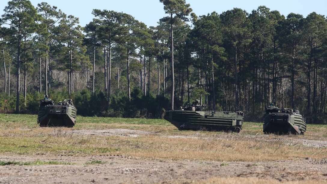 Amphibious Assault Vehicles with Alpha Company, 2nd Assault Amphibian Battalion, set up an offense posture as they take a notional enemy position on Marine Corps Base Camp Lejeune, N.C. Dec. 5, 2015. During the exercise the unit was moving as if they were a mechanized infantry unit, attached to a battalion landing team, in preparation for upcoming operations.