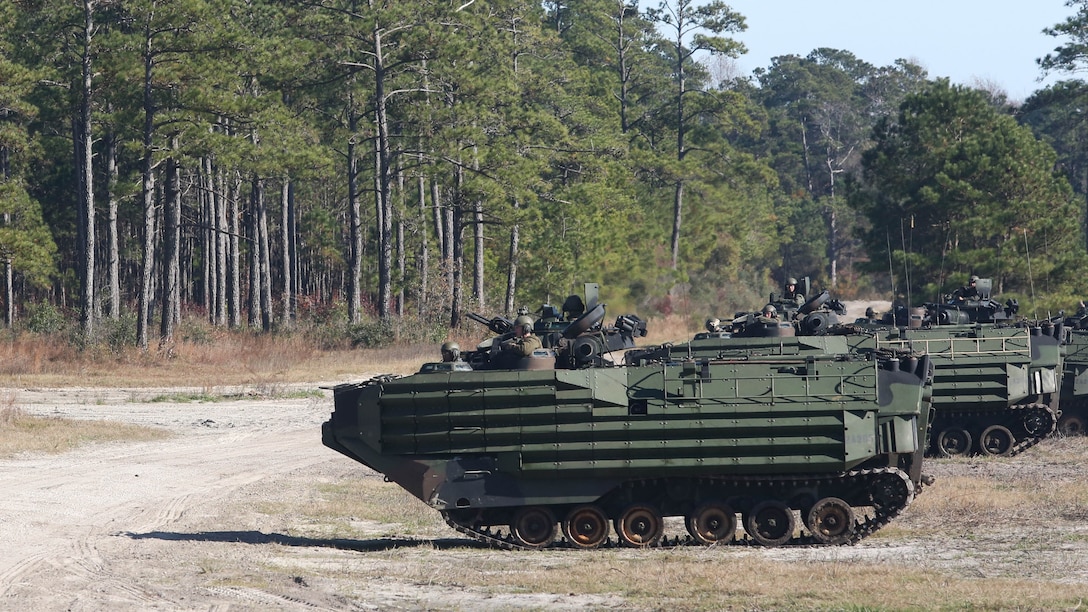 Amphibious Assault Vehicles with Alpha Company, 2nd Assault Amphibian Battalion, begin to take their inland objective while conducting company-level maneuvers on Marine Corps Base Camp Lejeune, N.C. Dec. 5, 2015. Moving as a company is rare for 2nd AAV Bn. as they are typically deployed as platoons. This training gave them the opportunity to work as one unit and take the objectives.