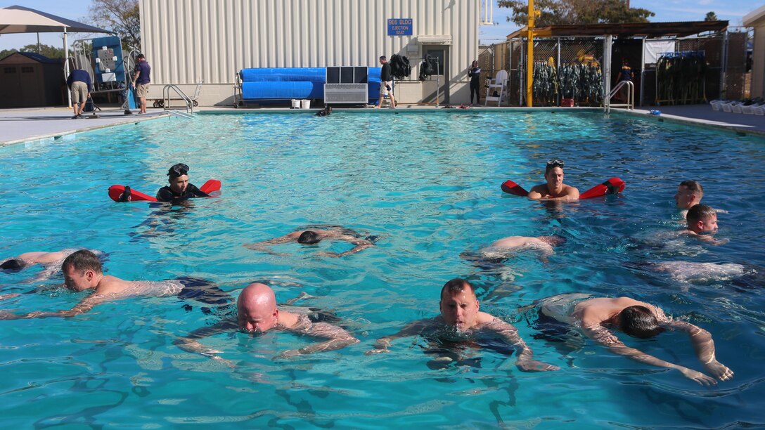 Marines and sailors train to float above water at the Aviation Water Survival Training Center at Marine Corps Air Station Miramar, Calif., Dec. 3, 2015. Aviation Water Survival Training is hosted every week, twice a week, and is mandatory for all pilots every four years. 