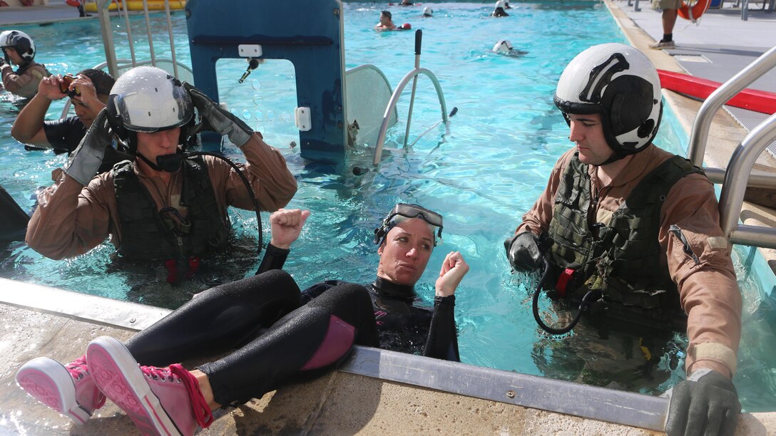 An Aviation Water Survival Training Instructor shows the students how to use their equipment at the Aviation Water Survival Training Center at Marine Corps Air Station Miramar, Calif., Dec. 3. Aviation Water Survival Training is hosted every week, twice a week, and is mandatory for all pilots every four years
