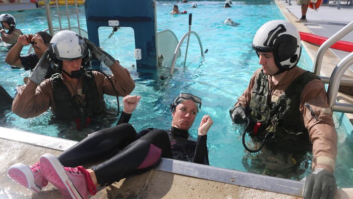 An Aviation Water Survival Training Instructor shows the students how to use their equipment at the Aviation Water Survival Training Center at Marine Corps Air Station Miramar, Calif., Dec. 3. Aviation Water Survival Training is hosted every week, twice a week, and is mandatory for all pilots every four years