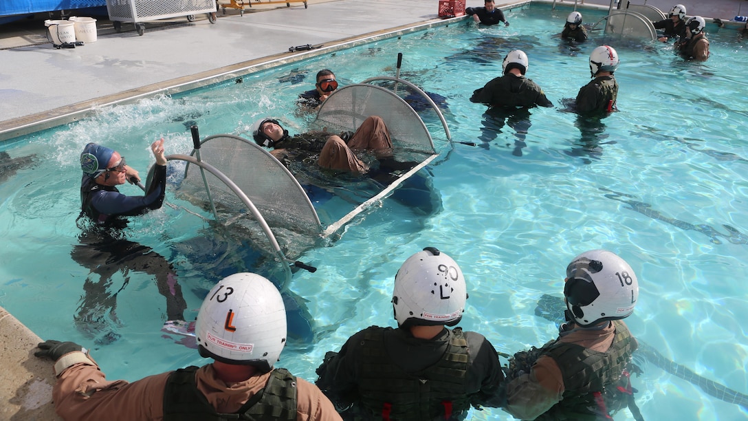 A student prepares to be dunked in the Modular Shallow Water Egress Trainer at the Aviation Water Survival Training Center at Marine Corps Air Station Miramar, Calif., Dec. 3, 2015. Aviation Water Survival Training is hosted every week, twice a week, and is mandatory for all pilots every four years. 