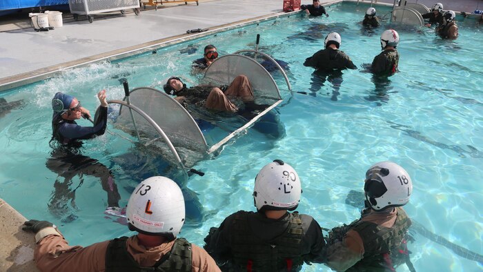 A student prepares to be dunked in the Modular Shallow Water Egress Trainer at the Aviation Water Survival Training Center at Marine Corps Air Station Miramar, Calif., Dec. 3, 2015. Aviation Water Survival Training is hosted every week, twice a week, and is mandatory for all pilots every four years. 