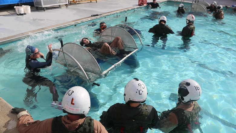 A student prepares to be dunked in the Modular Shallow Water Egress Trainer at the Aviation Water Survival Training Center at Marine Corps Air Station Miramar, Calif., Dec. 3, 2015. Aviation Water Survival Training is hosted every week, twice a week, and is mandatory for all pilots every four years. 