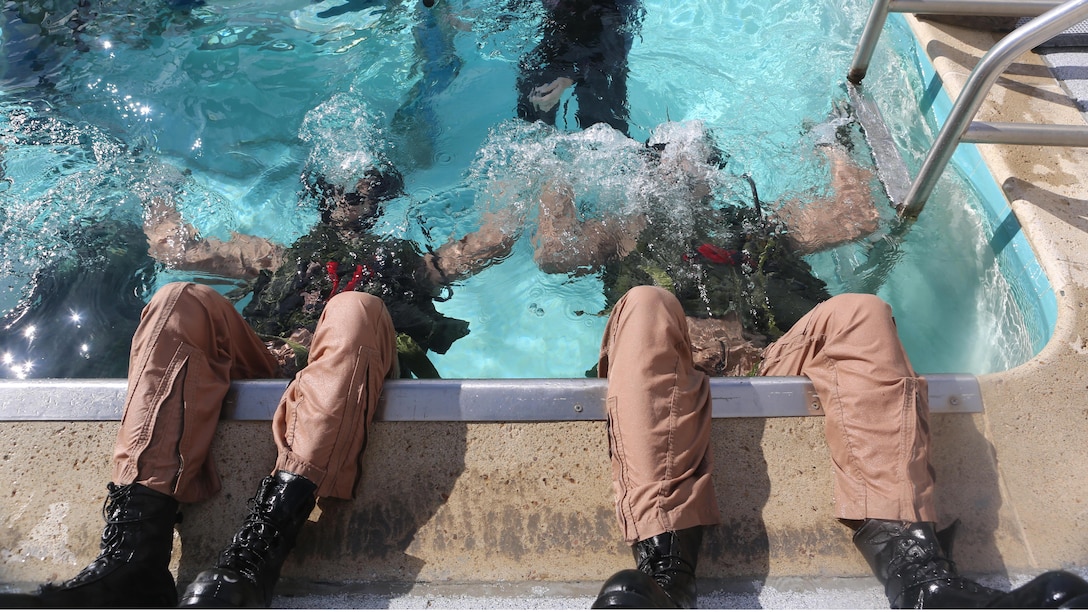 Students at the Aviation Water Survival Training Center train to use their equipment while upside-down underwater at Marine Corps Air Station Miramar, Calif., Dec. 3, 2015. Aviation Water Survival Training is hosted every week, twice a week, and is mandatory for all pilots every four years.
