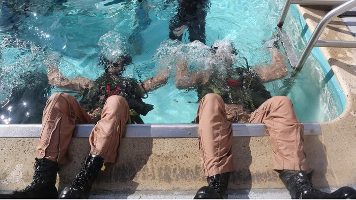 Students at the Aviation Water Survival Training Center train to use their equipment while upside-down underwater at Marine Corps Air Station Miramar, Calif., Dec. 3, 2015. Aviation Water Survival Training is hosted every week, twice a week, and is mandatory for all pilots every four years.