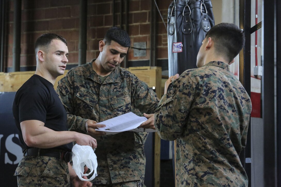 Marine students undergoing the Martial Arts Instructor Course review course material following a training session at Camp Lejeune, N.C., Dec. 4, 2015. The three-week long course will qualify its students to be Martial Arts instructors. The course’s development of endurance, strength, fighting ability and knowledge will benefit Marines for future operations in any location. (U.S. Marine Corps photo by Cpl. Paul S. Martinez/Released)