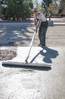 Tech. Sgt. Mike Rich, 90th Civil Engineer Squadron Pavements and Equipment, uses a bull float to smooth out large sections of newly poured concrete outside the Chadwell Dining Facility on F.E. Warren Air Force Base, Wyo., Nov. 10, 2015. 90th CES Airmen complete a wide range of maintenance and construction projects each year. (U.S. Air Force photo by Senior Airman Jason Wiese)