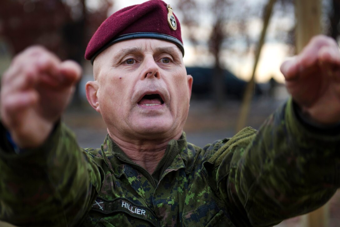 Canadian Armed Forces Sgt. Joe Hillier performs jumpmaster duties during the 18th Annual Randy Oler Memorial Operation Toy Drop on Camp Mackall, N.C., Dec. 7, 2015. Operation Toy Drop is the world's largest combined airborne operation during which service members help provide children in need with toys for the holidays.  U.S. Air Force photo by Staff Sgt. Douglas Ellis