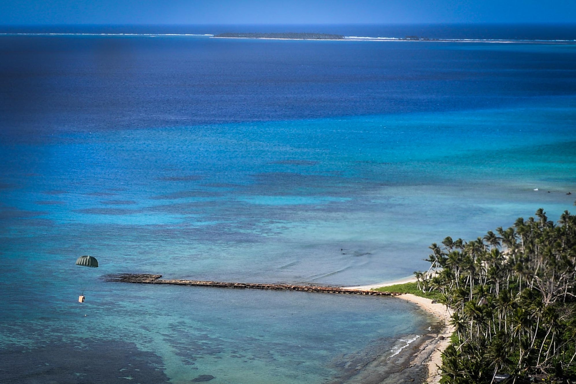 An Operation Christmas Drop bundle filled with critical supplies and donated goods descends to the ground Dec. 8, 2015 above the coastal waters of the remote Micronesian island of Asor. For the first time Australian and Japanese aircrews joined U.S. Airmen to execute the humanitarian aid/disaster relief training event where C-130 Hercules aircrews performed low-cost, low-altitude airdrops on unsurveyed drop zones while providing critical supplies to 56 islands. (U.S. Air Force photo/Staff Sgt. Alexander W. Riedel)