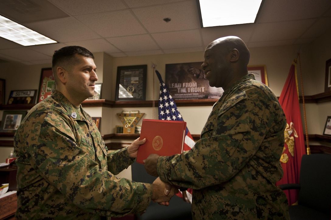U.S. Marine Corps Gunnery Sgt. Jorge Valdez is awarded the Navy Commendation Medal by the 18th Sergeant Major of the Marine Corps, Ronald L. Green, at the Pentagon, Arlington, VA, Dec. 9, 2015. (U.S. Marine Corps photo by Sgt. Melissa Marnell, Office of the Sergeant Major of the Marine Corps/Released)