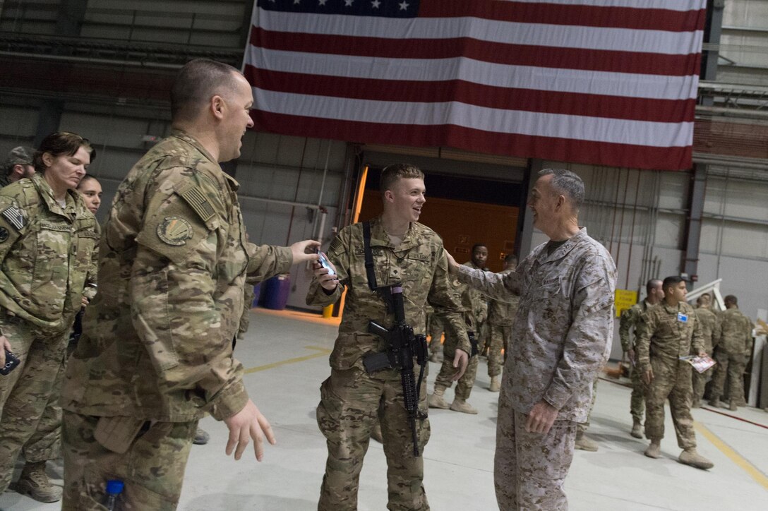 U.S. Marine Corps Gen. Joseph F. Dunford Jr., chairman of the Joint Chiefs of Staff, talks with U.S. service members after a USO show at Bagram Airbase, Afghanistan, Dec. 8, 2015. Dunford is traveling with USO entertainers to visit deployed service members on three continents during the holidays. DoD photo by D. Myles Cullen