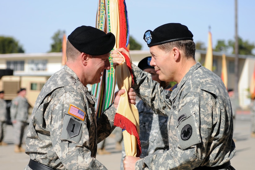 The Commander of the Army Reserve, Lt. Gen. Jeffrey Talley (right), passes the 79th Sustainment Support Command guidon to Maj. Gen. Mark Palzer, the incoming 79th Sustainment Support Command commanding general, at a change of command ceremony Dec. 5, 2015, at Joint Forces Training Base, Los Alamitos, Calif. (U.S. Army photo by Spc. Heather S. Doppke, 79th Sustainment Support Command)
