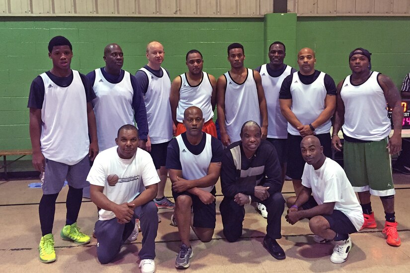 Lt. Col. Timothy Tyler with his volunteers and players at a midnight basketball league designed to occupy 18-35-year-olds from getting involved with gangs in St. Clair County and East St. Louis, Ill., which is known as the per capita murder capital of the United States.