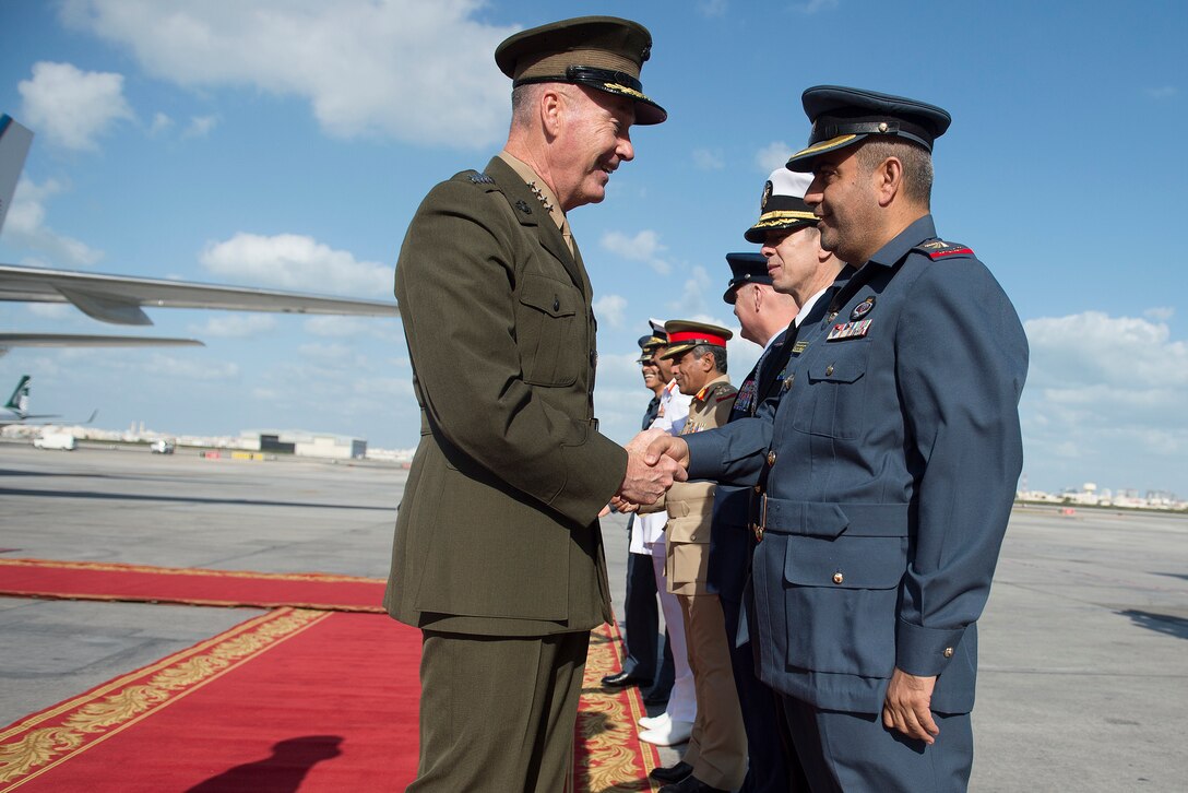 U.S. Marine Corps Gen. Joseph F. Dunford Jr., chairman of the Joint Chiefs of Staff, is greeted by senior officers of Bahraini military upon his arrival in Bahrain, Dec. 7, 2015. The chairman and the 2015 USO Holiday Tour were visiting deployed service members and their families on three continents to express the country's gratitude for their service. DoD photo by D. Myles Cullen