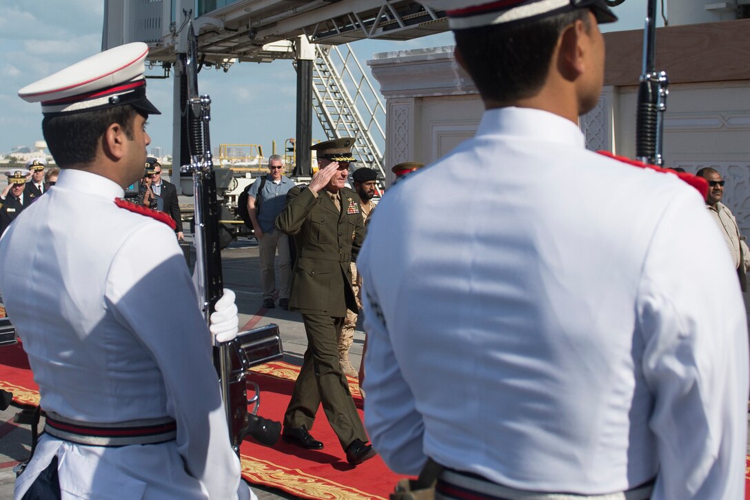 U.S. Marine Corps Gen. Joseph F. Dunford Jr., chairman of the Joint Chiefs of Staff, salutes a Bahraini military honor guard as he arrives at the airport in Bahrain, Dec. 7, 2015. DoD photo by D. Myles Cullen